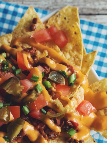 overhead of a plate of vegan chili nachos with cheese