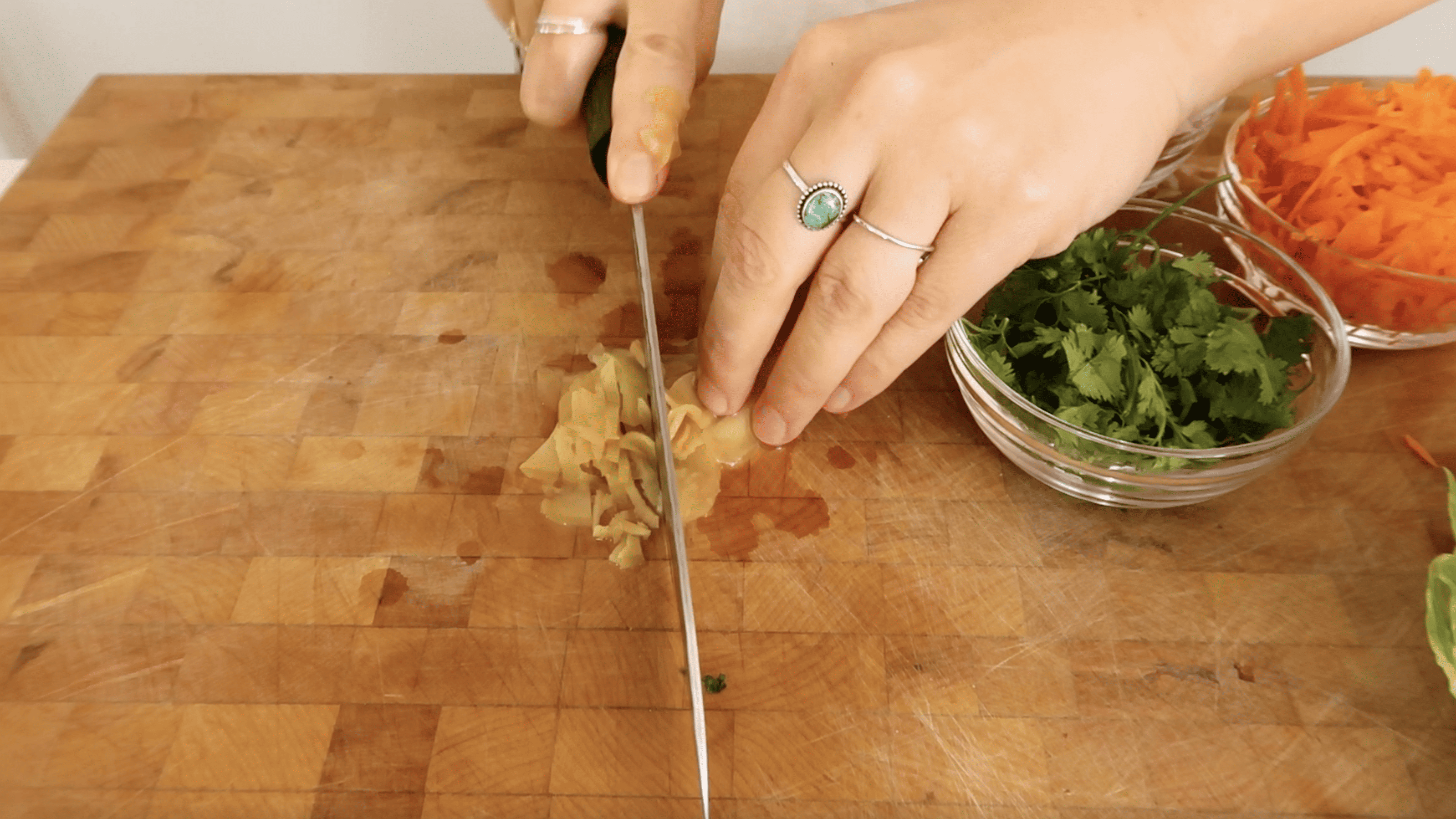 hands chopping pickled ginger
