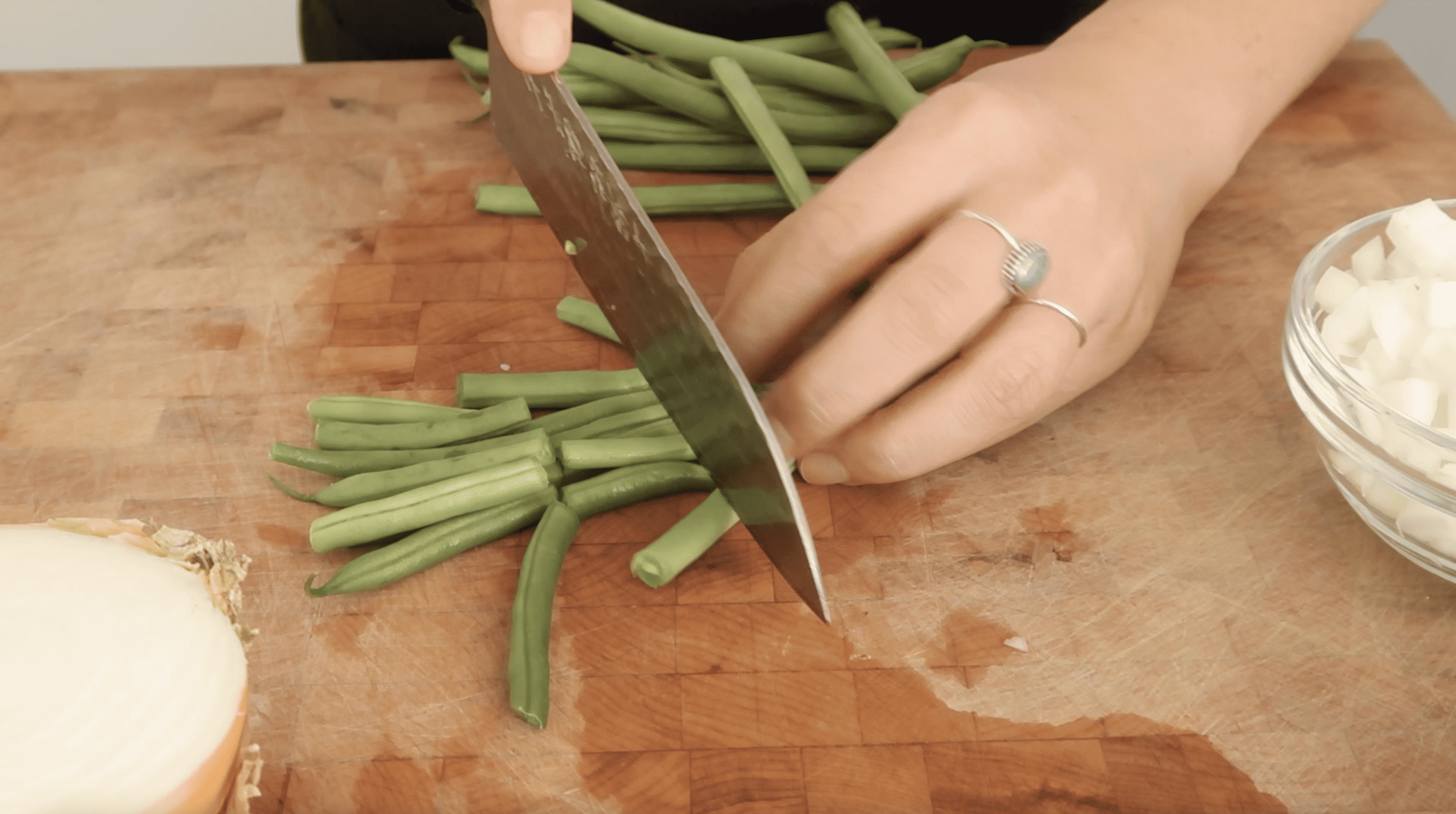 a knife cutting green beans
