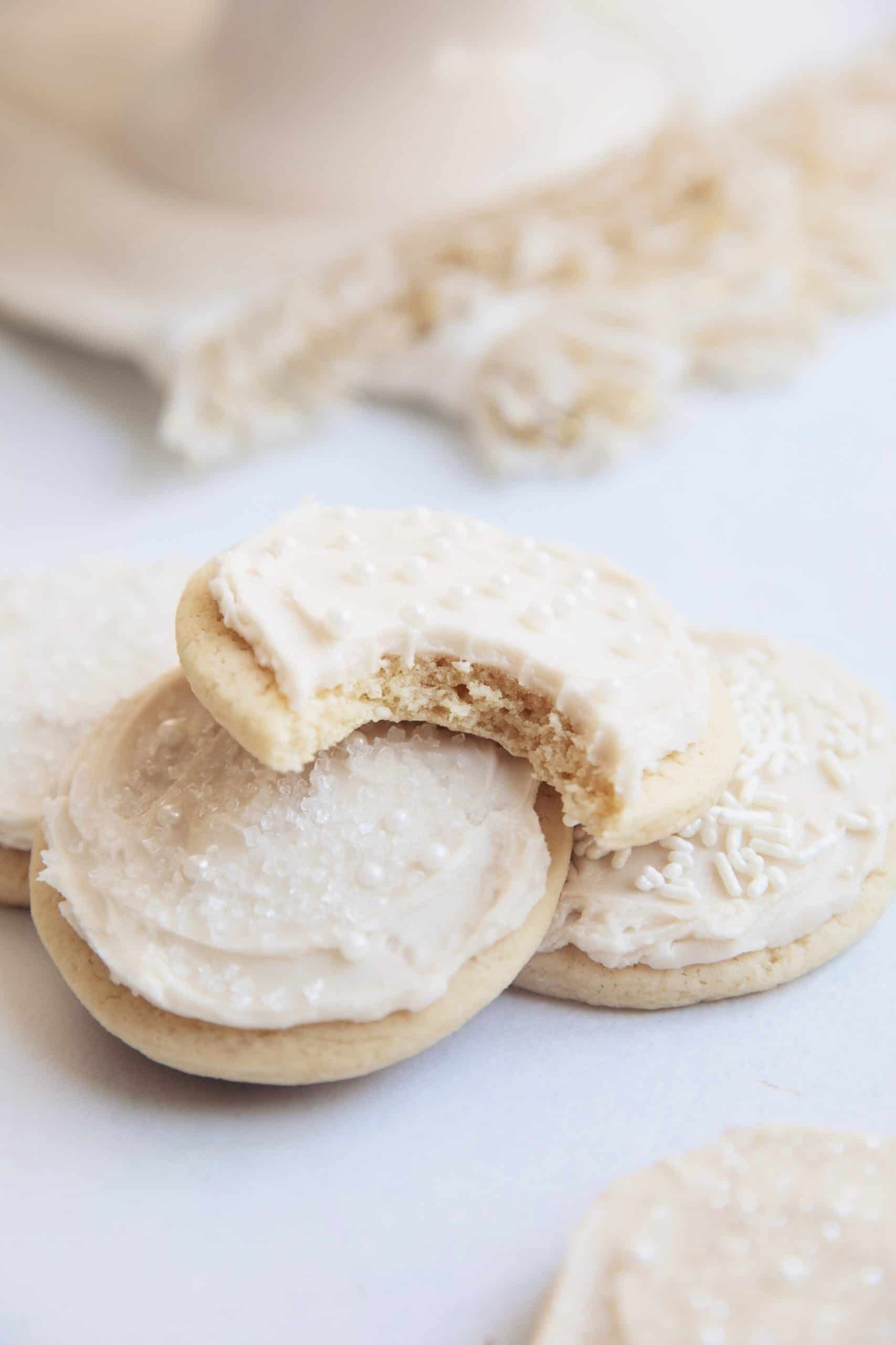 diners view of snowball sugar cookies with a bite removed to show the inside