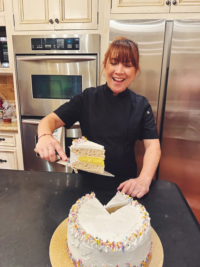 Chef Lauren Toyota serving vegan celebration cake